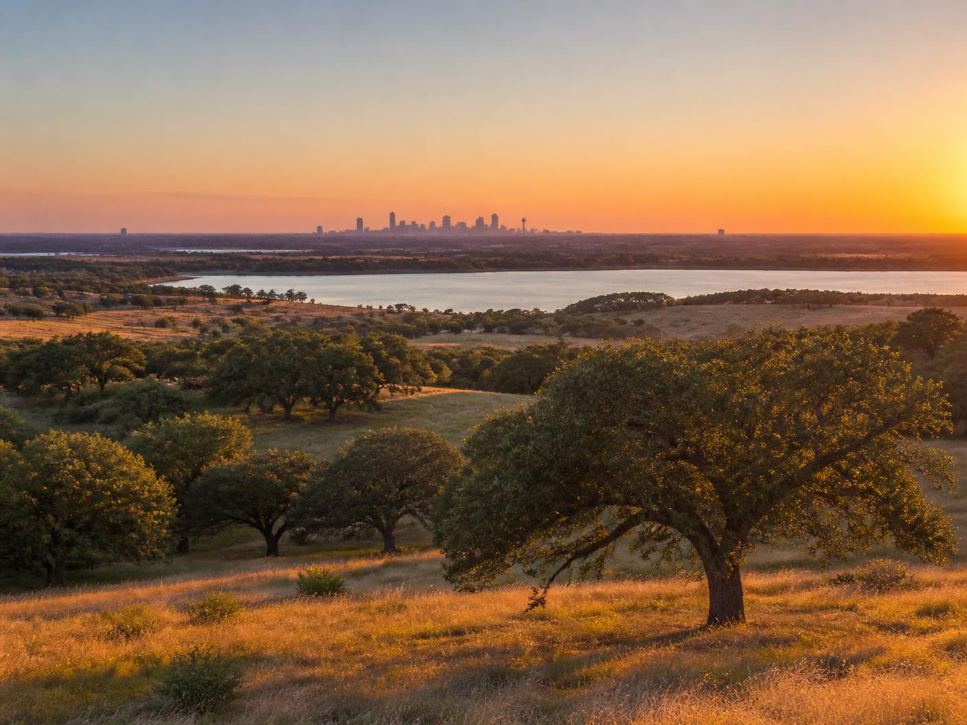 North Texas landscape at sunset with the Dallas–Fort Worth skyline on the horizon